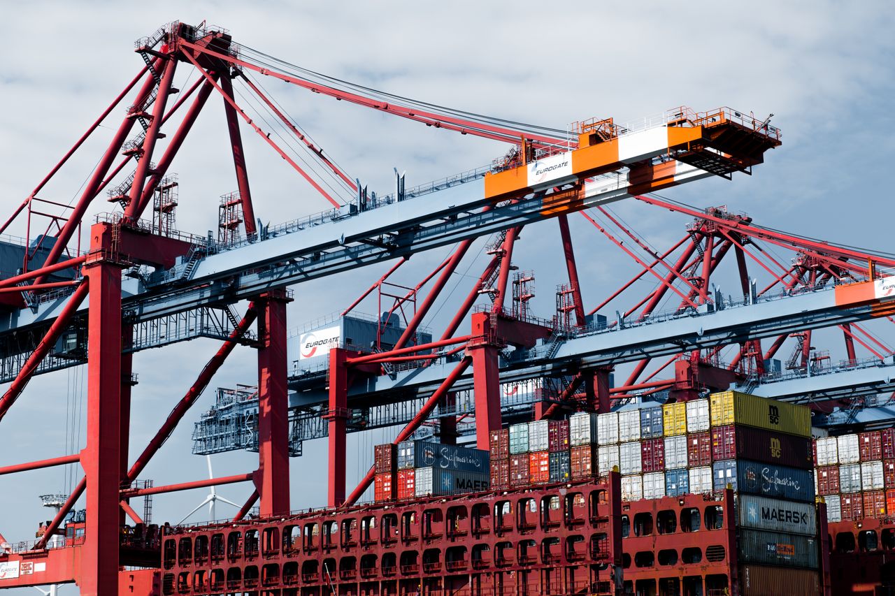 Home Cranes and shipping containers at Hamburg port, a hub of industry and trade.